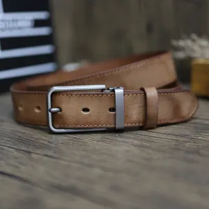 Detailed view of brown retro distressed genuine leather men belt with metal pin buckle.