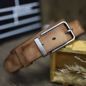 Vintage genuine leather belt detail shot showcasing retro distressed cowhide and pin buckle.