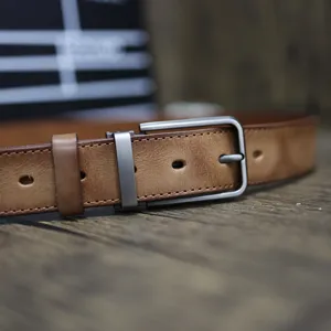 Vintage genuine cowhide leather belt detail showcasing craftsmanship, retro pin buckle.