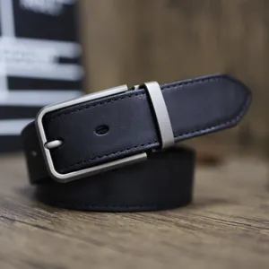 Leather belt detail close-up showing fine texture and durable metal pin buckle craftsmanship.