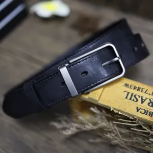 Close-up of black genuine leather men belt with vintage metal pin buckle, cargo style detail.