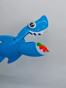 Blue plastic shark grabber bath toy closeup view, featuring interactive mouth and colorful fish.