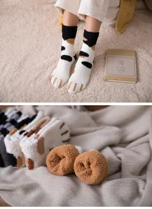 Cozy coral fleece winter sleep socks with cute cat paw design, soft and warm home flooring.