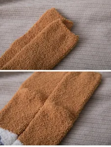 Detail shot of cozy women winter fluffy coral fleece sleep socks, soft warm plush texture.