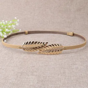 Thin leather dress belt for women with elegant gold leaf buckle, stylish waist accessory.