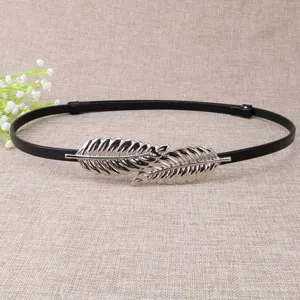 Minimalist black thin leather dress belt with elegant silver double leaf metal buckle detail.