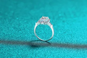 Close-up of S925 sterling silver moissanite ring with emerald cut center stone.