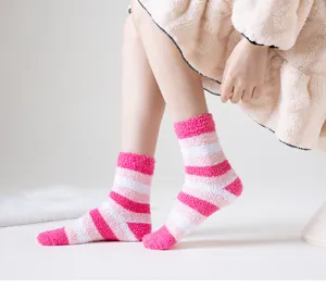 Cozy pink striped fuzzy socks for women, soft coral fleece floor socks for autumn and winter.