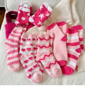 Cozy pink fuzzy plush socks for women, cute winter warm sleep floor socks with sweet heart patterns.