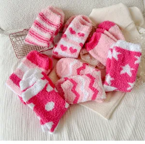 Cute pink fuzzy socks detail view, soft coral fleece winter home floor socks for women.