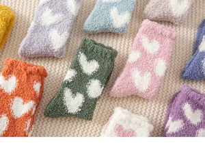 Cozy fuzzy coral fleece socks with cute white heart pattern, warm winter sleep socks for women.