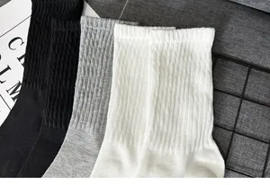 Detailed view of classic ribbed mid-calf socks in black, grey, and white colors.