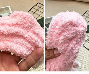 Detailed view of women's pink coral fleece fuzzy warm winter thick sleeping socks texture.
