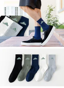 Close-up of mountain embroidery and ribbed texture on cotton crew socks in multiple colors.