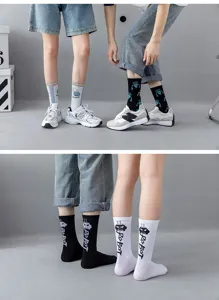 Close-up detail of street style cotton mid-tube socks with letter graphics and ribbed cuffs.