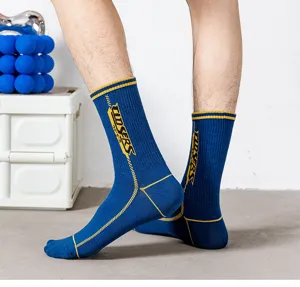Detail view of blue mid-calf athletic socks with yellow stripes and side typography.