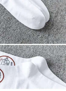 Close-up detail shot of white cotton mid-tube socks featuring a unique camera print graphic.