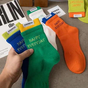 Men's colorful mid-tube cotton socks with embroidery letters and comfortable ribbed cuffs.