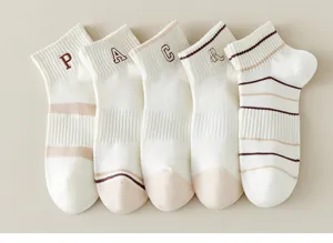 Detailed view of cute Japanese style short cotton socks for women, featuring embroidered letters and stripes.