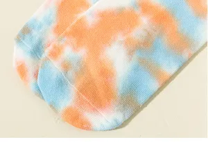 Close-up view of vibrant orange and blue tie-dye yoga and pilates socks detail texture.