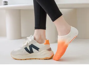 Close-up detail of gradient non-slip pilates yoga socks paired with trendy casual sneakers.