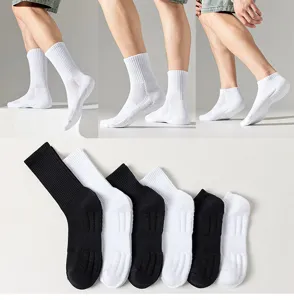 Detail shot of men's athletic terry bottom socks, showing breathable mesh and black white pairs.