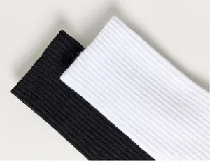 Close-up detail view of ribbed cotton socks showing elastic knit texture in classic colors.