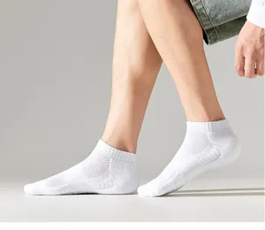 Men's athletic short white socks detail view, breathable mesh and comfortable cushioned sole.