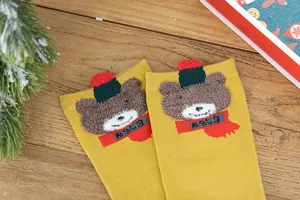 Gros plan détaillé de chaussettes en coton d'hiver ours dessin animé 3D jaune.