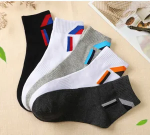 Close-up detail view of colorful cotton athletic crew socks with geometric stripe patterns.