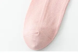 Close-up detail of women pink breathable mesh short socks, lightweight summer hosiery.