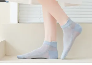 Light blue mesh low-cut socks close-up, breathable hollow-out texture for spring and summer.
