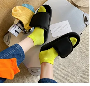 Detailed shot of trendy women solid color short socks paired with stylish platform sandals.
