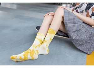 Close-up detail of yellow tie-dye mid-calf socks worn by model on skateboard street style.