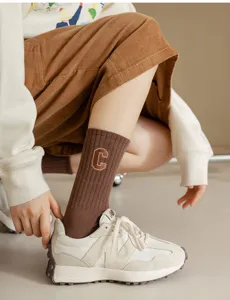 Detailed view of brown ribbed cotton socks featuring a stylish embroidered letter C design.