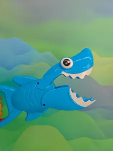 Blue shark grabber toy detail showing the movable mechanical jaw and bright plastic body.