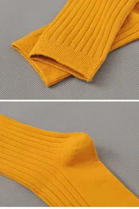 Detail view of men's casual yellow ribbed cotton mid-tube socks showing breathable knit texture.