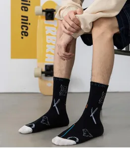 Men black mid-tube cotton socks with white toe and doodle monster prints for daily streetwear style.