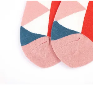 Close-up detail shot of colorful geometric pattern knit socks, showing fine texture.