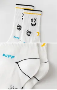 Men's white mid-tube athletic cotton socks with trendy graffiti and stripes for daily wear.