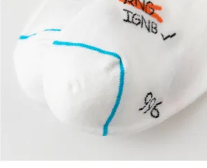Close-up detail of white cotton sports socks featuring blue stripe accents and distinct print text.