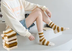 Detailed shot of striped distressed mid-tube socks, stylish retro design for daily streetwear.