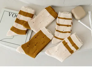 Detailed view of women hollow knit socks, vintage distressed striped design, soft cotton.