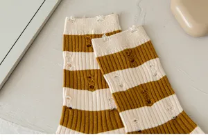 Detailed view of women distressed striped mid-calf socks, vintage casual summer cotton hosiery.
