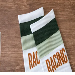 Green striped white sport crew socks detail view, breathable cotton casual socks.