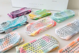 Detailed view of colorful tie-dye yoga socks with non-slip anti-skid dots for fitness.
