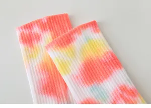 Detailed view of women tie dye yoga socks showing colorful gradient ribbed cuff texture.