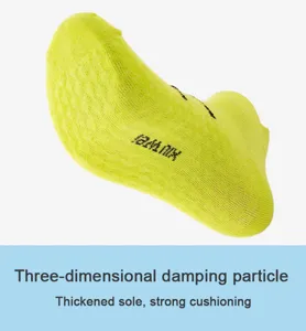 Close-up detail of neon green athletic short socks with thickened damping sole and particles.