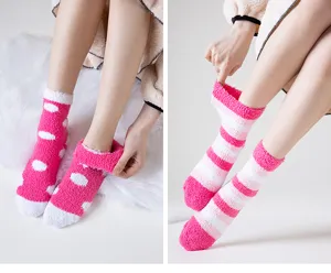 Detailed view of women cozy pink fluffy fleece socks with cute patterns for indoor comfort.