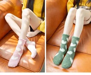 Women's thick coral fleece winter sleep socks with cute heart pattern for cozy home wear.